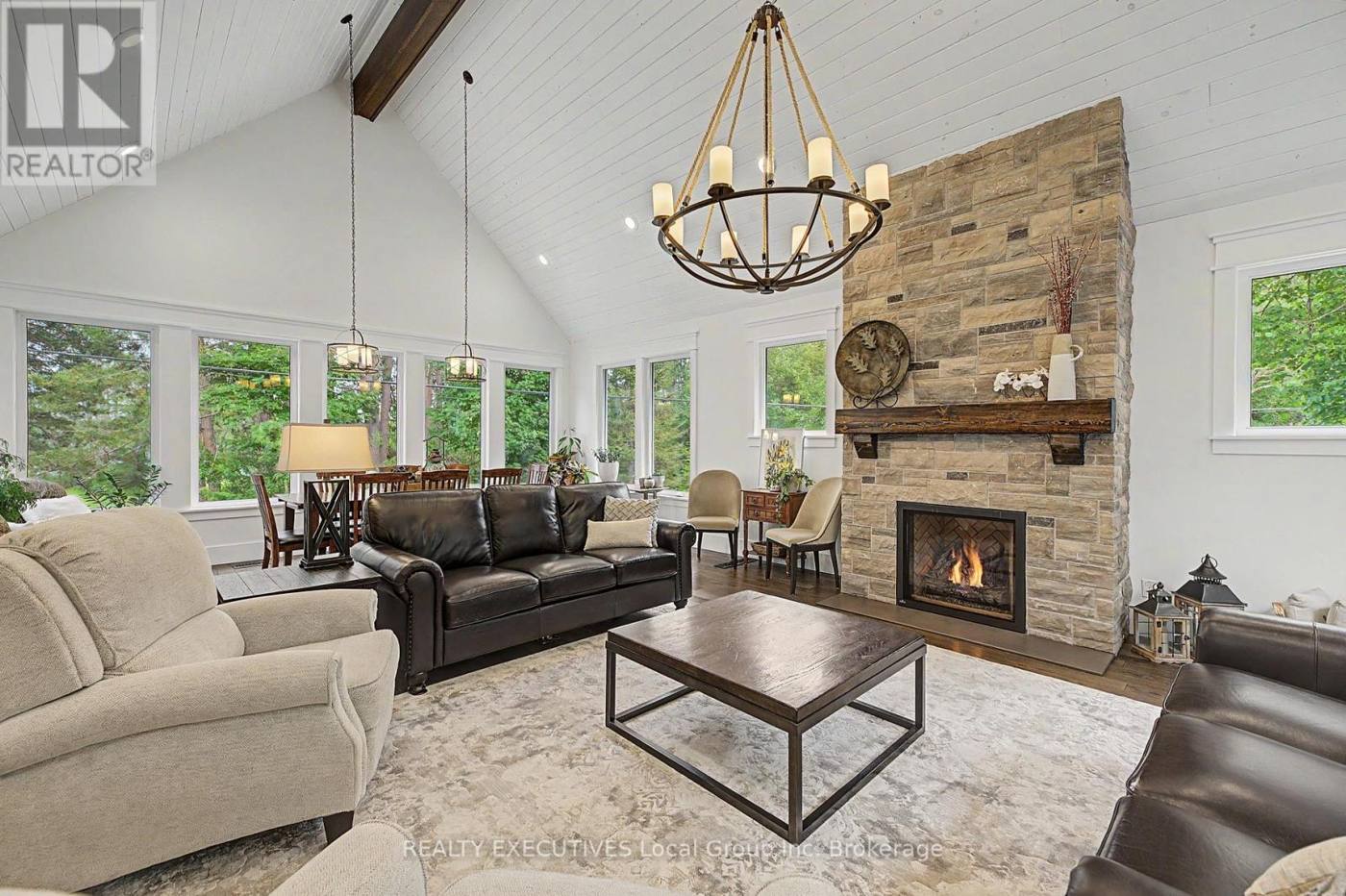 Great room with vaulted ceiling and stone fireplace